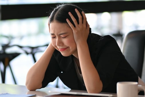 Concept of frustration. Woman with hands on her head. 