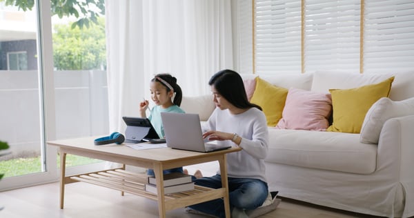 Adult asia people single mom small SME owner support happy sit busy apply child tax credit refund plan form app or pay loan bill on laptop. Little kid girl play at home hybrid job career workforce.