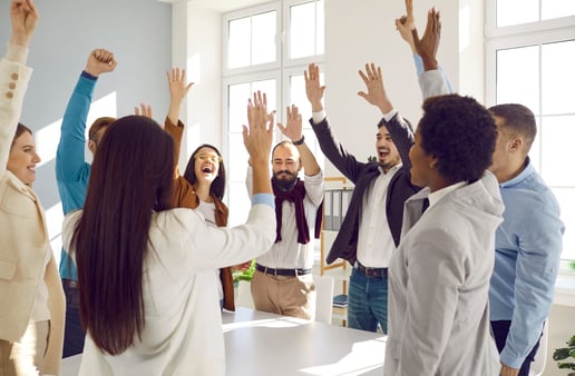 A group of people celebrating with their hands in the air