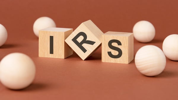 Three wooden blocks spelling out the letters IRS
