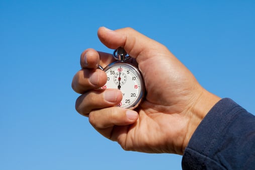 The concept of pausing governmental and mental health parity requirements. A hand holding a stopwatch. 