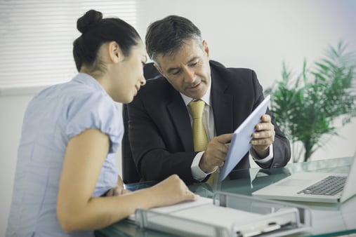 Employer discussing important business with an employee and client