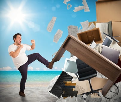 A man karate-kicking an office desk 