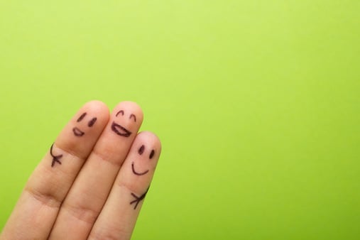 Three fingers with happy faces drawn on them