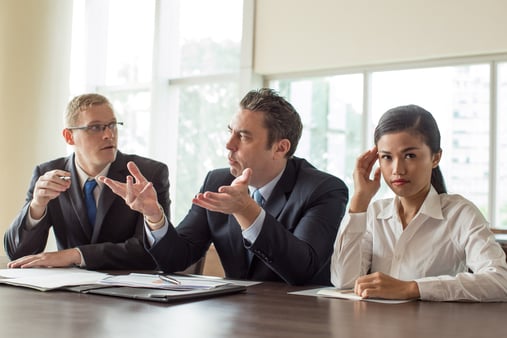 Two people on a team talking to each other while ignoring the third team member, reinforcing similarity bias 