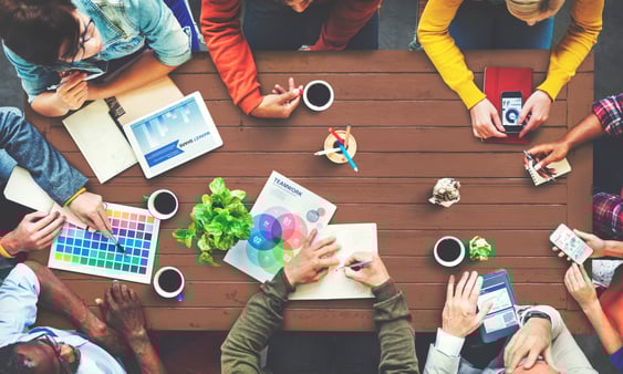 A team sitting at a table and creatively brainstorming