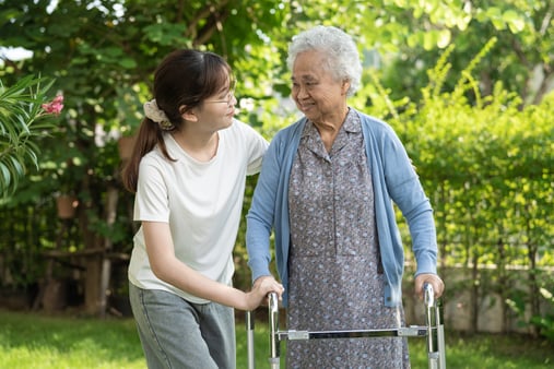 Caregiver help and care. Asian senior or elderly old lady woman use walker.