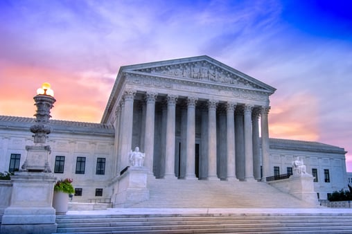 The United States Supreme Court with a sunrise in the background 