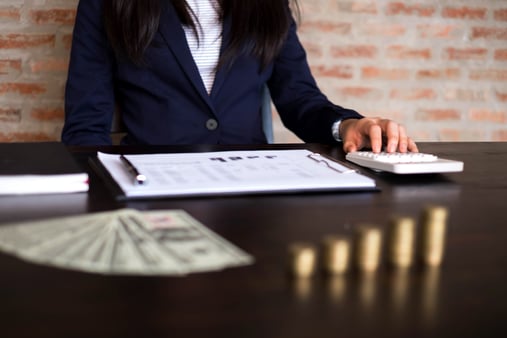 Businesswoman with a contract and money on the table