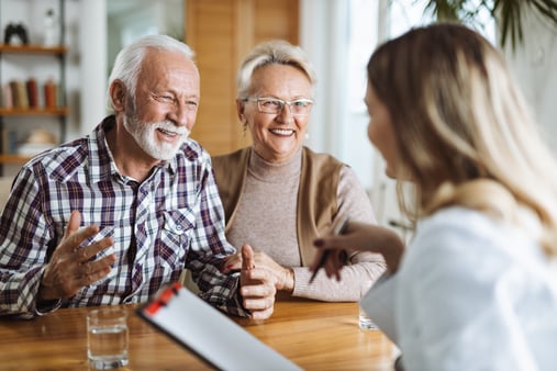 Concept of Medicare. Medicare age couple talking with a nurse. 