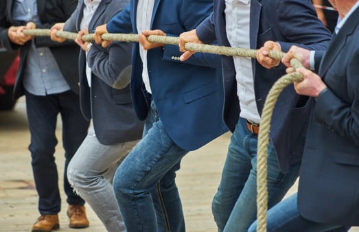Concept of the tug of war between RTO and flexibility. Businesspeople pulling at a tug of war rope.