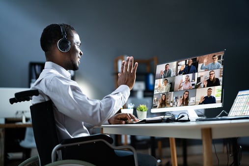 Man waving goodbye to people on a Zoom call 