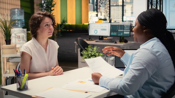 An employee discussing employee benefits with HR