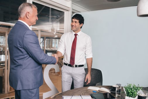 A man shaking hands with another man 