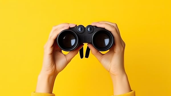 Hands holding binoculars, the concept of Zoom In, Zoom Out