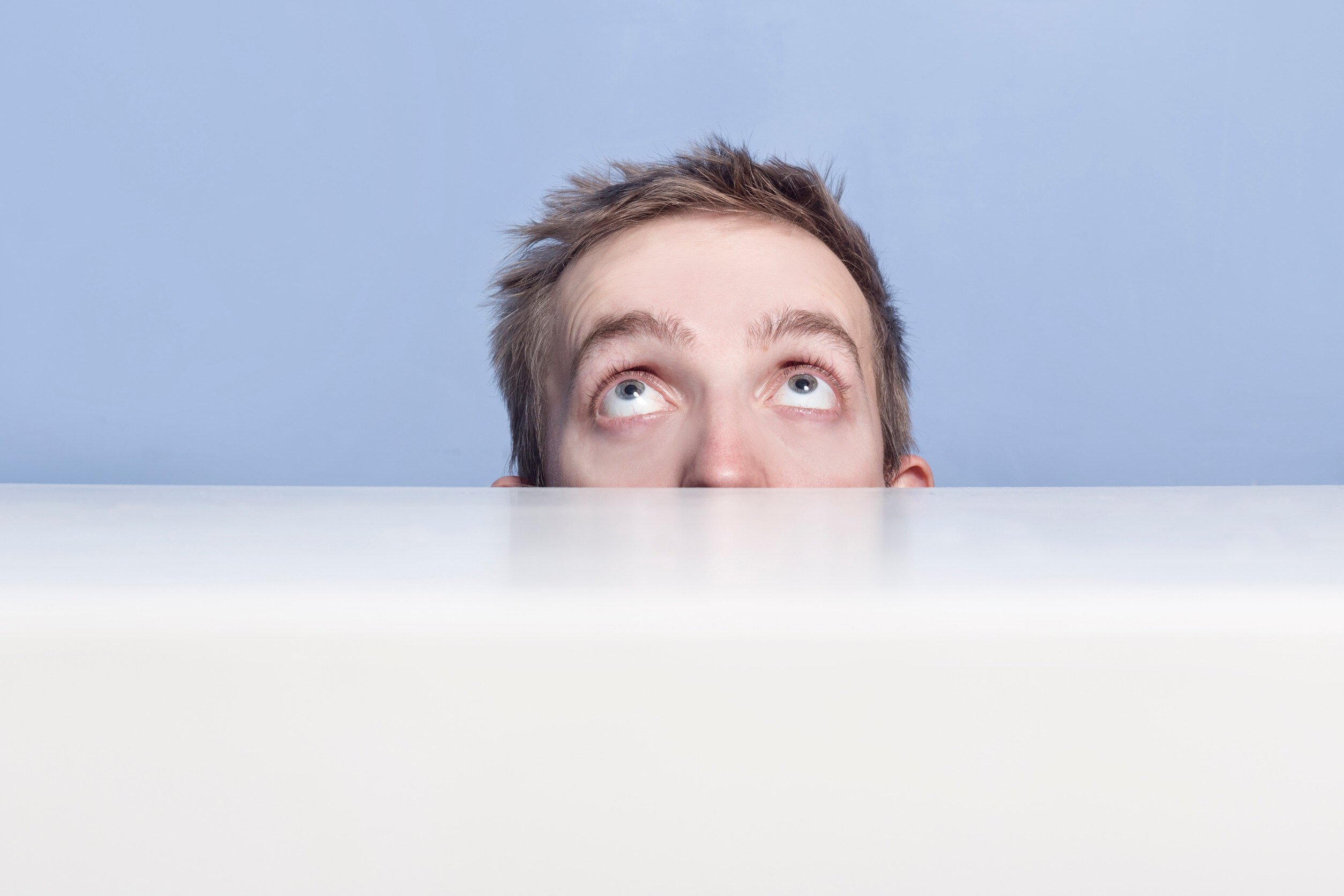 The concept of excuses. A man hiding behind a counter. 