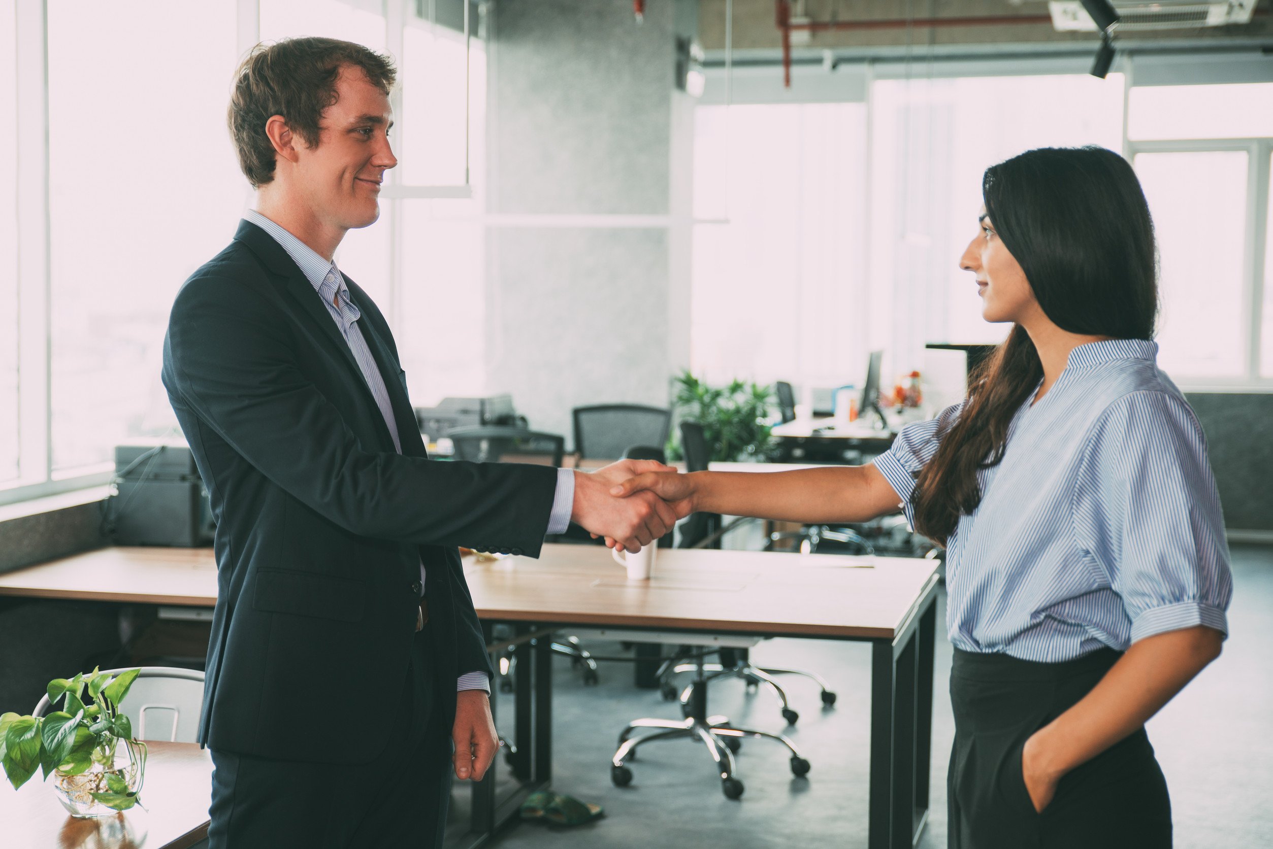 A professional in business attire in person, looking sincere or empathetic, visually representing accountability and care