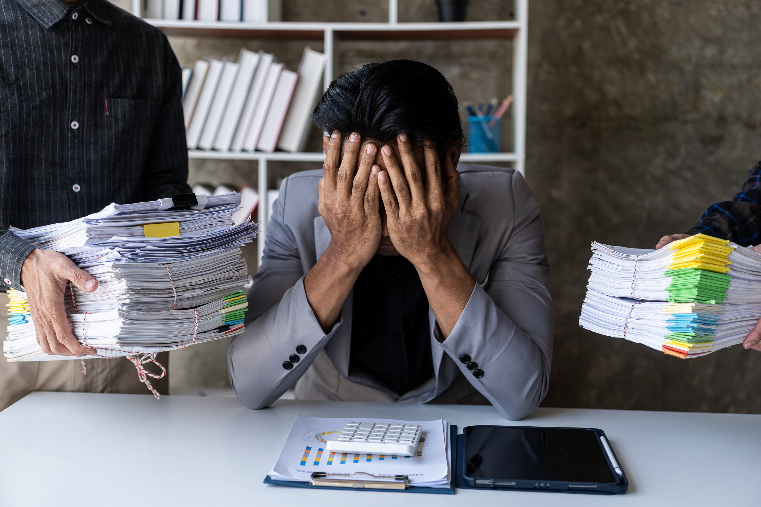 The concept of chaos. A businessperson getting overwhelmed by documents and tasks. 